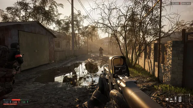 First-person firefight down a flooded village street, Control Zone owner shown on the HUD